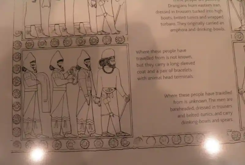 Traveling people, one holding a double headed animal bracelet Traveling people, one holding a double headed animal bracelet